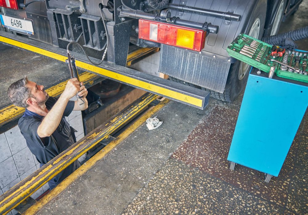attentive-mechanic-checking-pressure-in-the-wheels-2021-09-03-14-19-16-utc-min